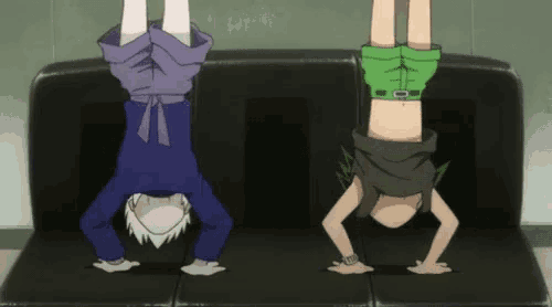 two anime characters are doing handstands on a black couch