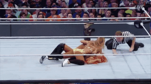 two women are wrestling in a wrestling ring with a referee and the word live on the bottom