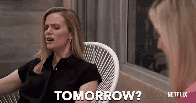 a woman sits in a chair and says " tomorrow " next to another woman