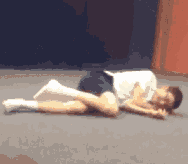 a blurry picture of a man laying on the floor