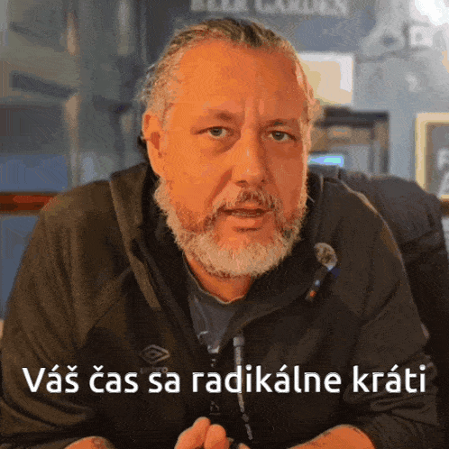 a man with a beard is wearing a black jacket with the words vas cas sa radicalne krati on the bottom