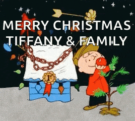 a christmas card with charlie brown holding a christmas tree