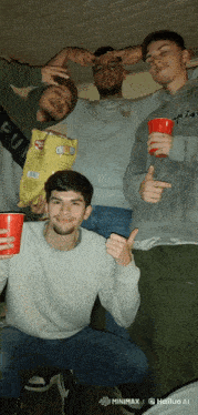 a group of young men are posing for a picture with one holding a bag of chips