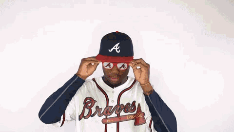 a baseball player wearing a hat and sunglasses with the letter a on them