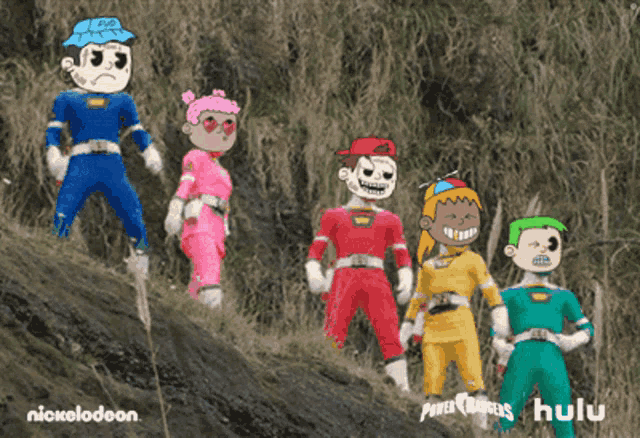 a group of power rangers standing on a hill