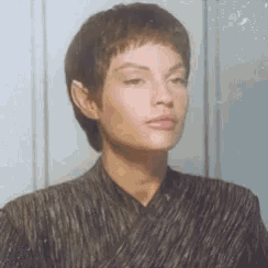 a close up of a woman 's face with a striped shirt and ears .