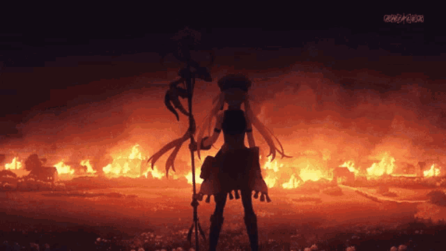 a silhouette of a woman holding a staff in front of a fire with the letters ntv on the bottom