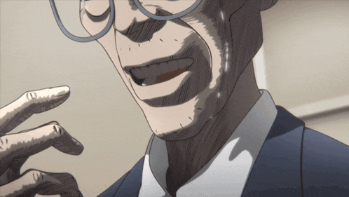 a man with glasses and a suit is smiling