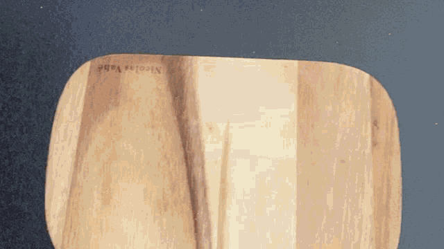 a wooden cutting board with the name nicolas varb on it