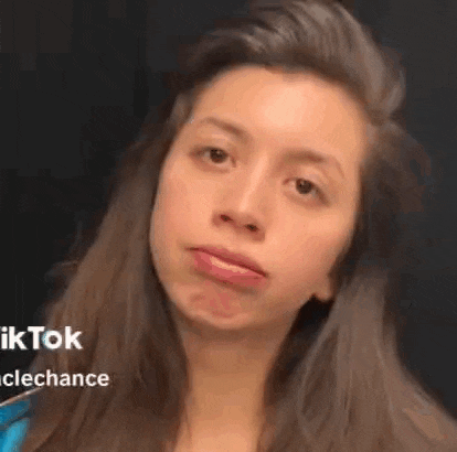 a woman with long hair is making a funny face .