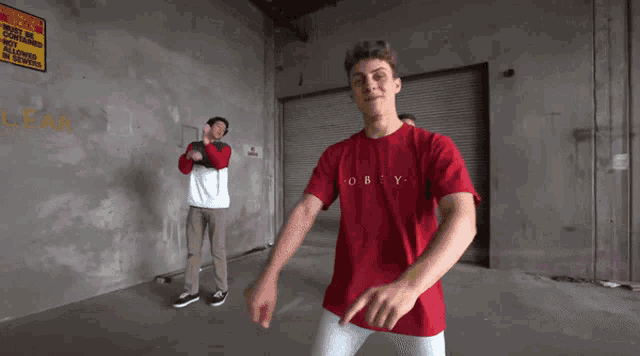 a man wearing a red shirt that says nobody is pointing