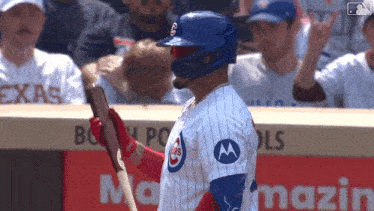 a chicago cubs baseball player holds his bat up