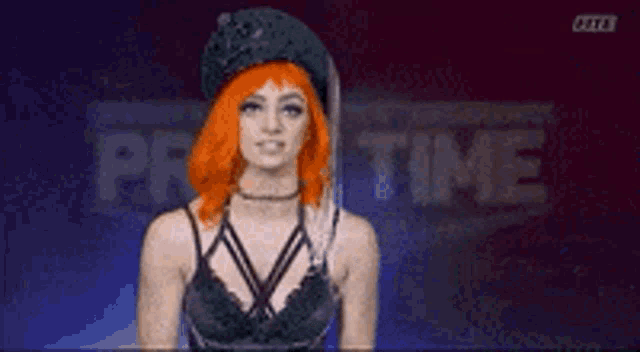 a woman with red hair and a black hat is standing in front of a sign that says pro time .