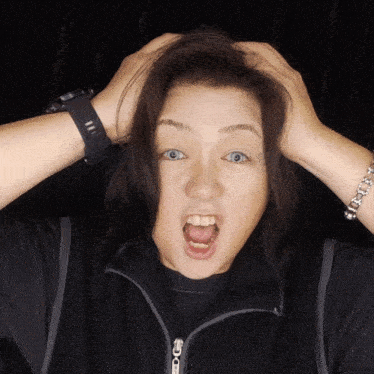 a woman wearing a g-shock watch holds her hair