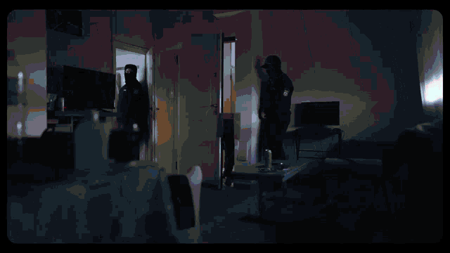 a person is standing in a room with a red light behind them