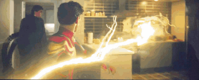 a man in a spiderman costume is holding a lightning bolt