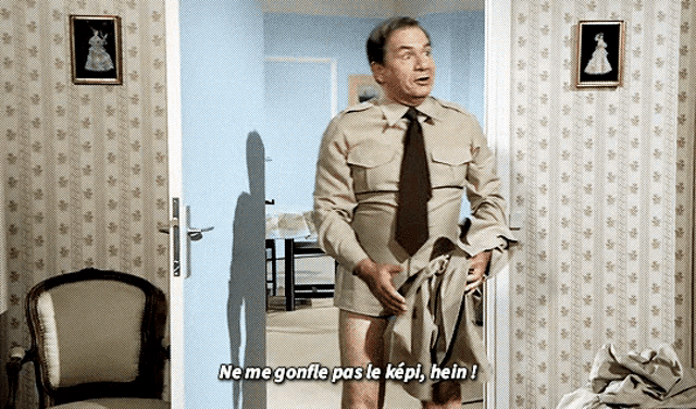 a man standing in a doorway with the words ne me gonfle pas le kepi hein written above him