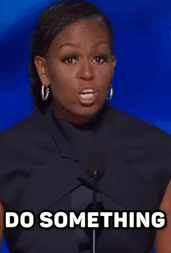 michelle obama is giving a speech in front of a microphone and says `` do something '' .