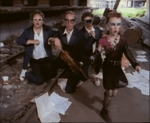 a group of people wearing sunglasses and goggles are kneeling down on the ground