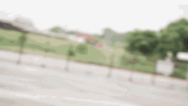 a blurry picture of a fence and trees in the background