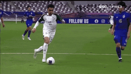 a soccer player with the number 11 on his jersey is running on the field