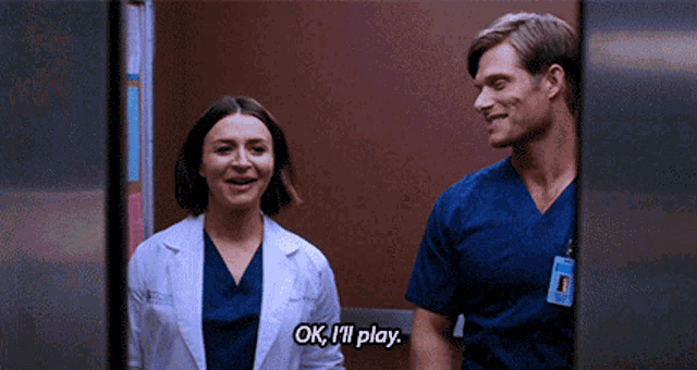 a man and a woman are standing next to each other and the woman says ok i 'll play .