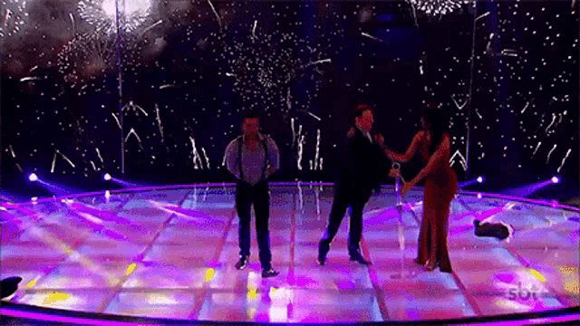 a group of people dancing on a stage with the letters sbt on the bottom