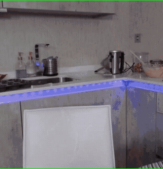 a kitchen with a blue light on the cabinets