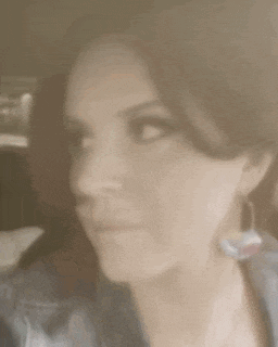 a close up of a woman 's face with a serious expression .