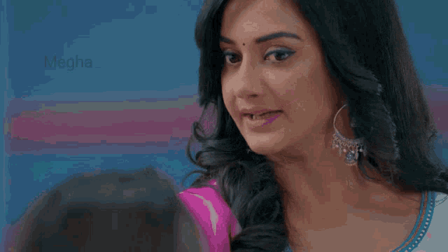a close up of a woman 's face with the word megha visible