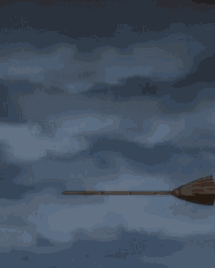 a girl is flying through the air while another girl is on a broom