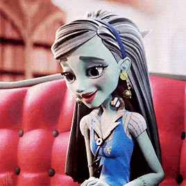 frankenstein from monster high is sitting on a red couch