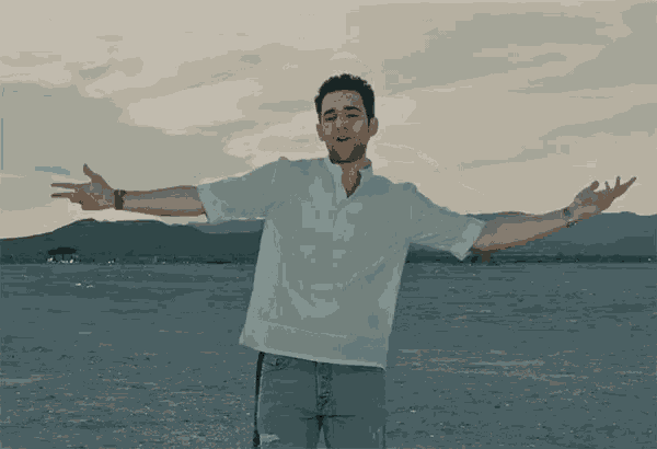 a man with his arms outstretched in a desert