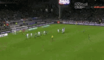 a soccer game is being played on a field with a football club advertisement