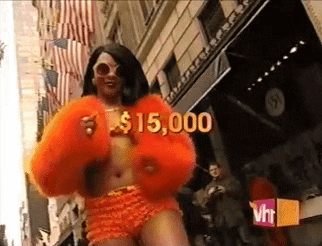 a woman in an orange fur coat is walking down the street