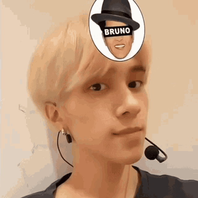 a young man wearing a microphone and a hat has bruno written on his face