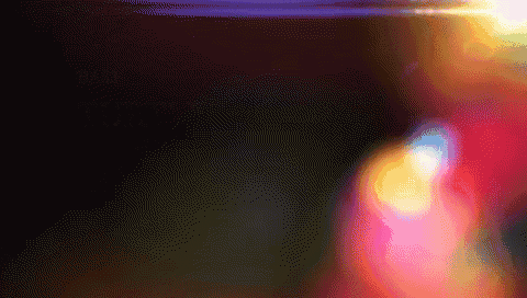 a blurred image of a person 's face with a purple light behind them