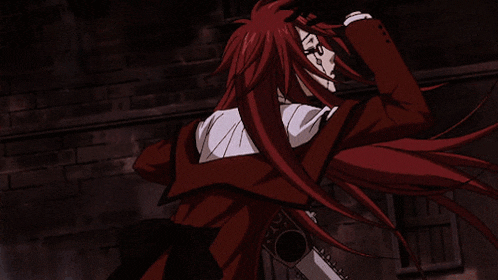 a man with long red hair is wearing a black vest