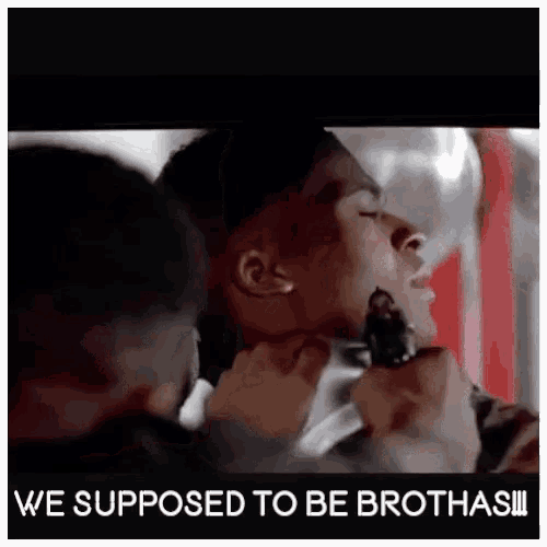 a man is being choked by another man and the caption says we supposed to be broths !!!