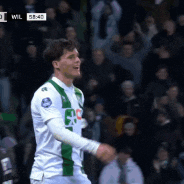 a soccer player wearing a white and green uniform with the number 80 on the back