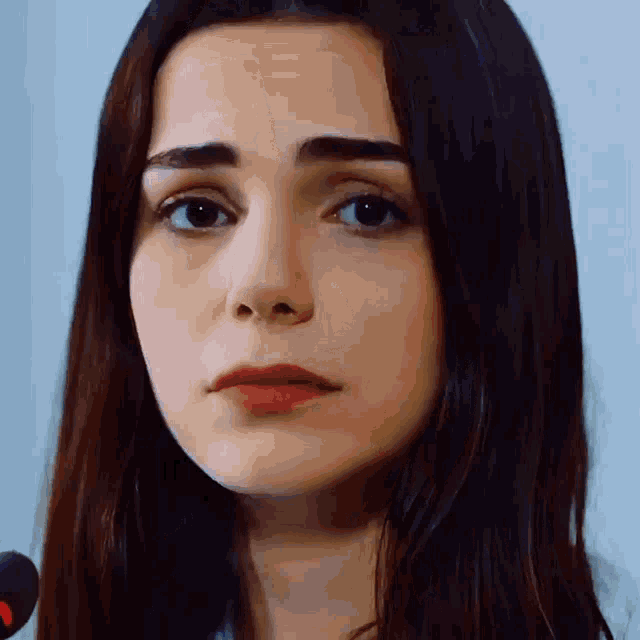 a close up of a woman 's face with a serious look on her face