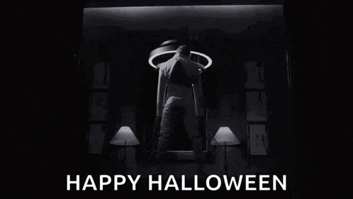 a black and white photo of a man standing in a dark room with the words `` happy halloween '' written below him .