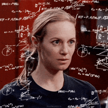 a woman stands in front of a wall of mathematical equations and formulas