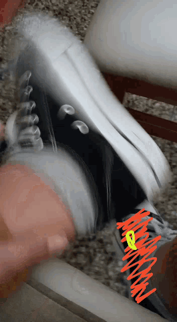 a person is wearing a pair of black and white converse sneakers