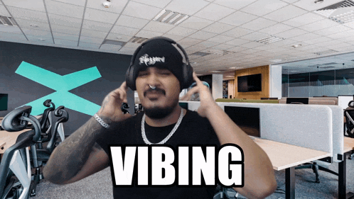 a man wearing headphones with the word vibing written on it