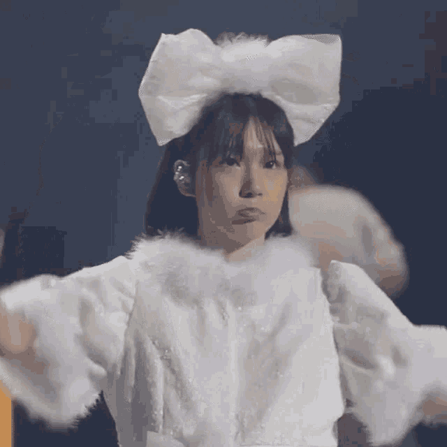 a woman wearing a white bow on her head