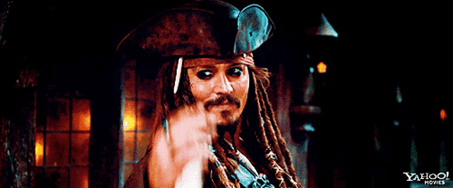 a man with dreadlocks wearing a pirate hat with the yahoo movies logo on the bottom