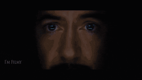 a close up of a person 's face with the word filmy on the bottom left