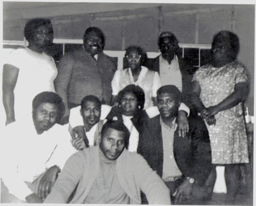 a black and white photo of a group of people posing