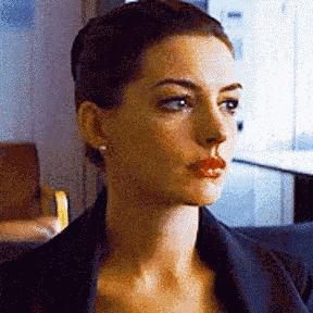 a close up of a woman 's face with a bun